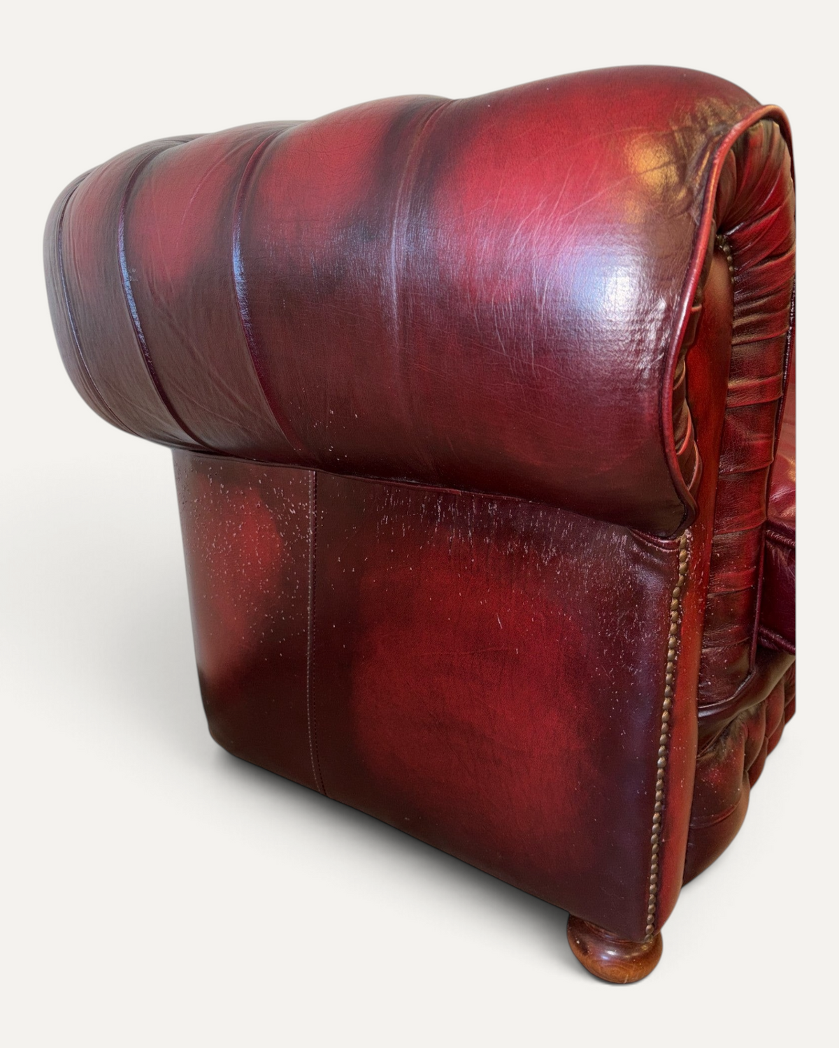 Chesterhome vintage Chesterfield 3-seater sofa side view in oxblood leather with brass nailhead trim