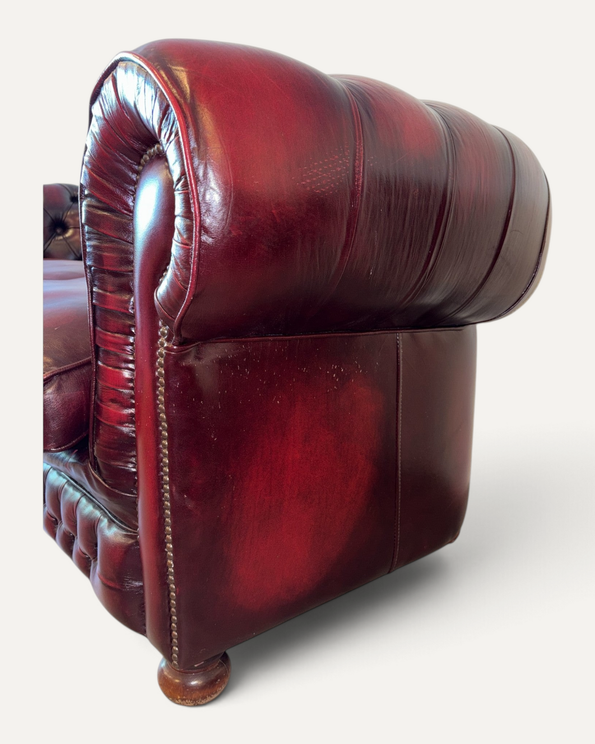 Chesterhome vintage 3-seater Chesterfield sofa in oxblood leather with tufted back, rolled arms, and brass nailheads.