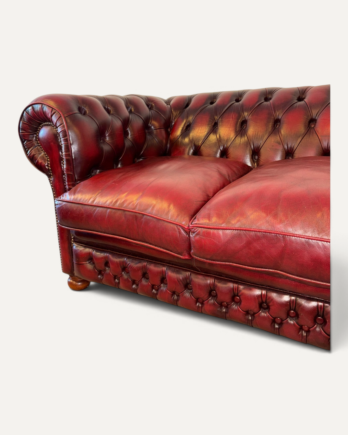 Chesterhome vintage 3-seater Chesterfield sofa in oxblood leather with tufted back, rolled arms, and brass studs.