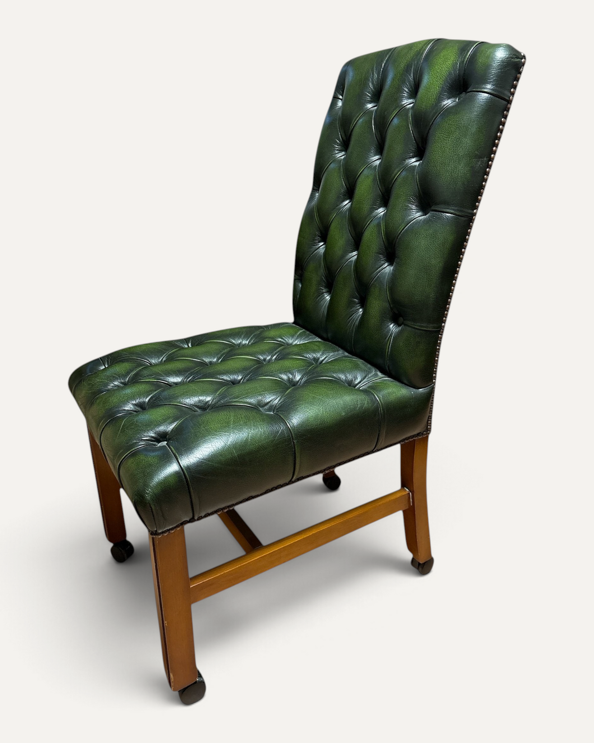 Chesterhome vintage green leather Chesterfield office chair with button tufting, brass studs, and wooden frame.