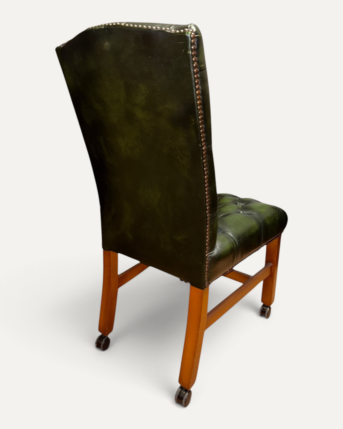 Chesterhome vintage green leather Chesterfield office chair with button tufting, brass studs, and wooden frame.